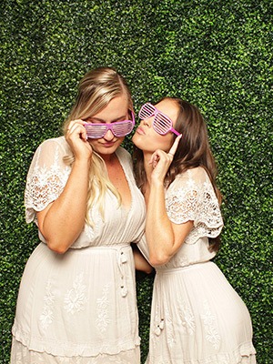 creative booth girls posing on green wall